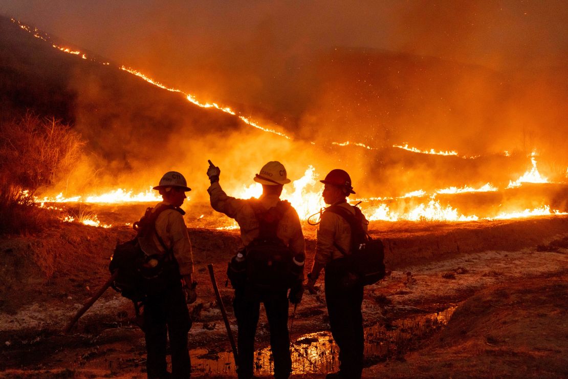 Fire crews battle the Kenneth Fire in the West Hills section of Los Angeles on Thursday.