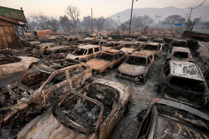 Vehicles charred by the Eaton Fire sit inside a dealership in Altadena, California, on Friday, January 10.