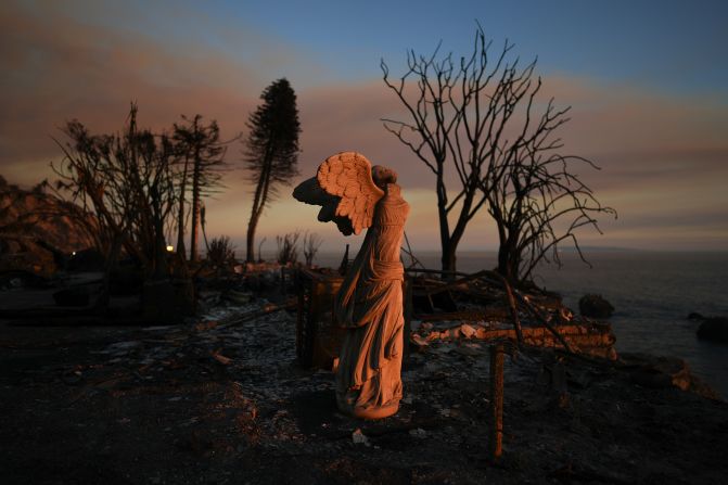 A statue stands amid damage from the Palisades Fire in Malibu on Friday, January 10.