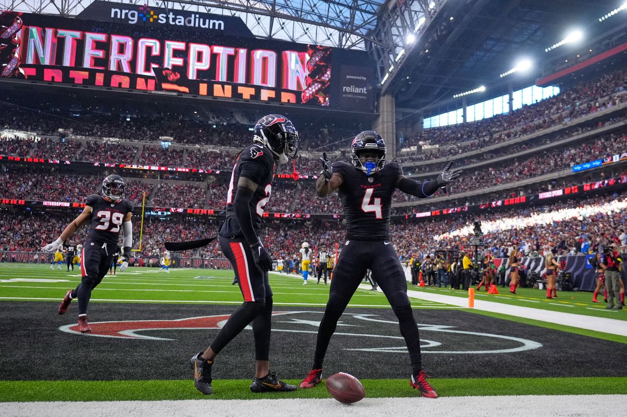 Houston Texans cornerback Kamari Lassiter celebrates with Calen Bullock after intercepting a pass.