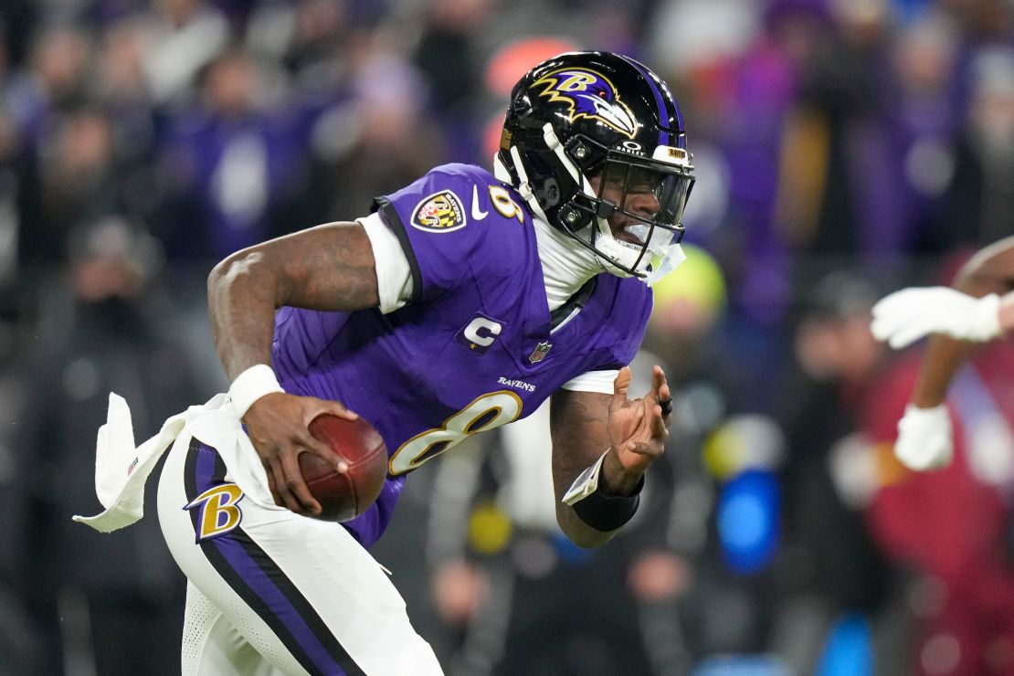 Baltimore Ravens quarterback Lamar Jackson runs with the ball during the first half of an NFL wild card playoff football game against the Pittsburgh Steelers.