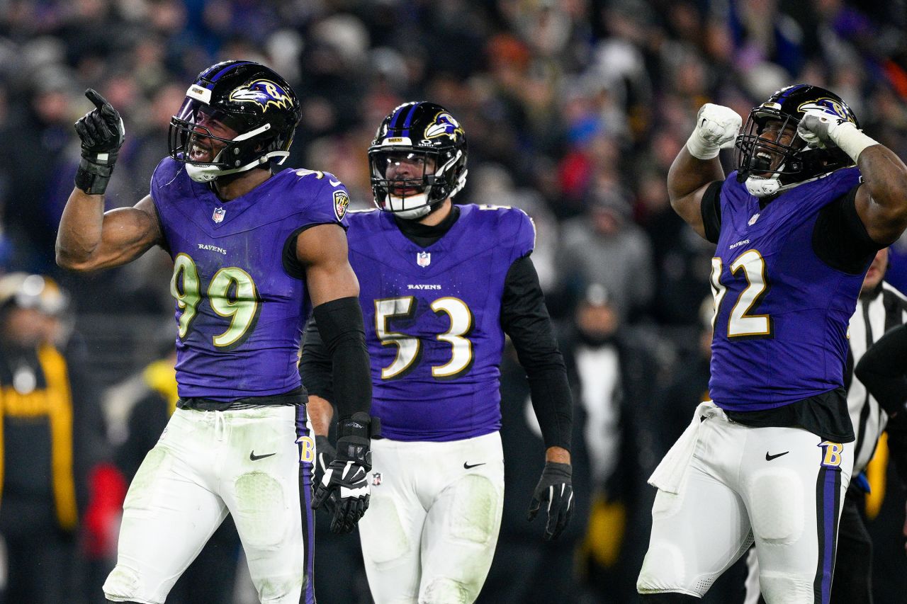 Baltimore Ravens linebacker Odafe Oweh, left, celebrates a sack with teammates.