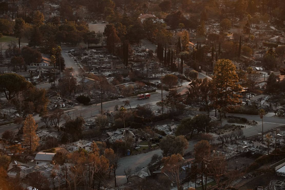 A firetruck drives through a neighborhood destroyed by the Eaton Fire on January 14 in Altadena, California.