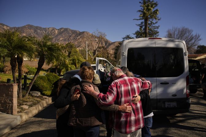 Members of Calvary Disaster Relief pray with a local after the Eaton Fire damaged the neighborhood, Wednesday, Jan. 15, 2025, in Altadena, Calif. (AP Photo/John Locher)