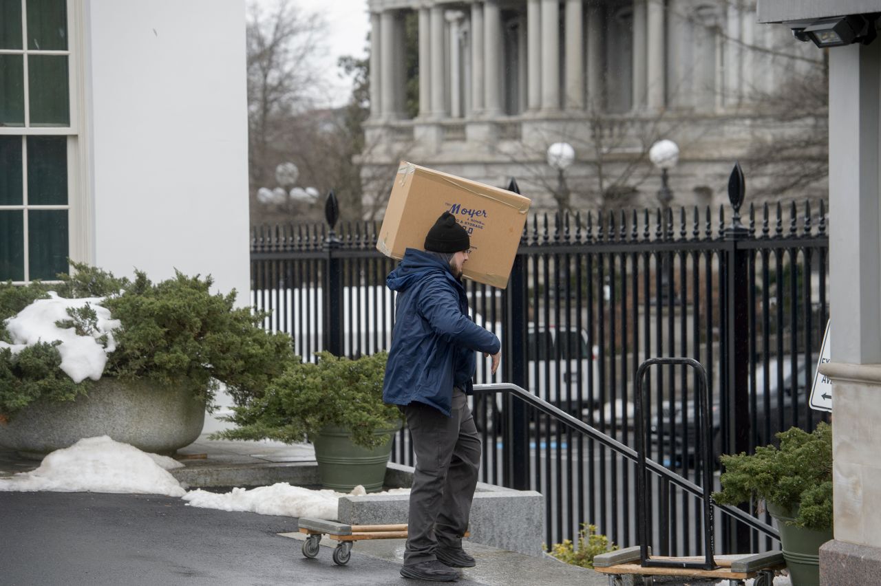 Movers load trucks at the White House grounds on Saturday.