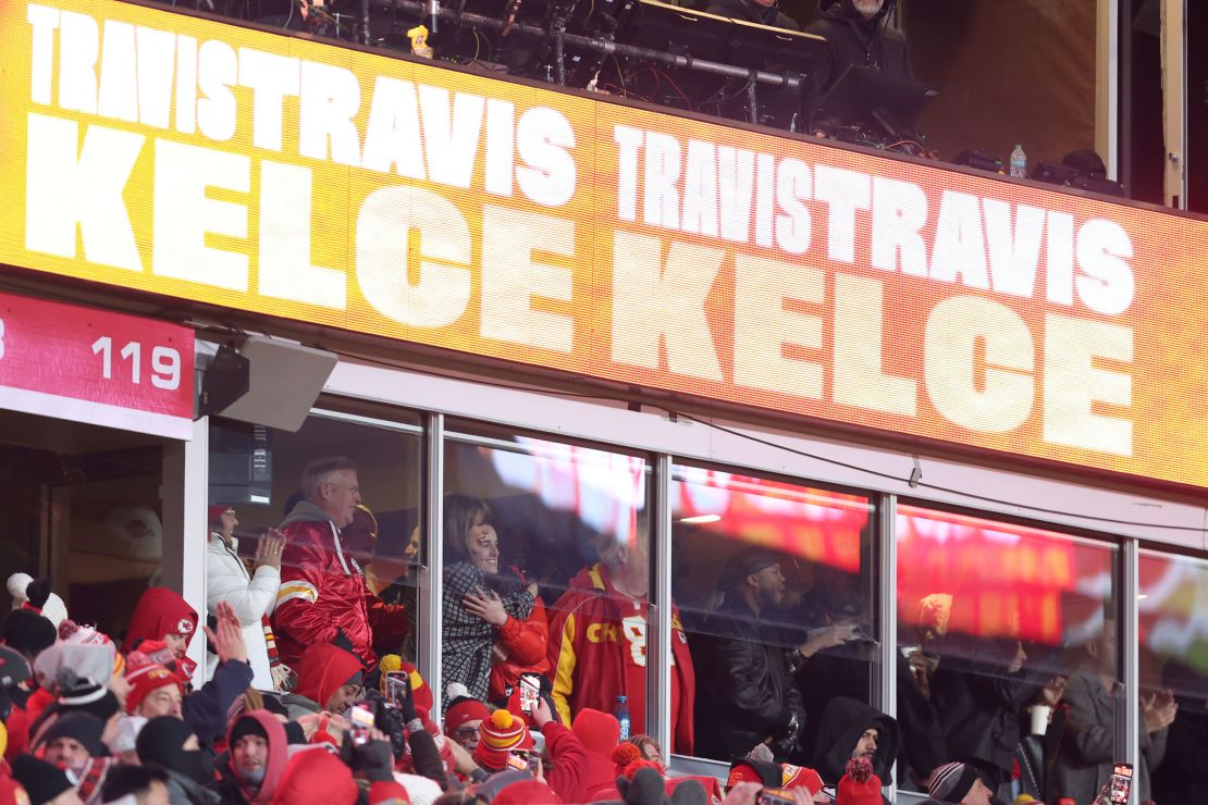 Taylor Swift hugs Caitlin Clark, right, as they celebrate with Swift's father, Scott Swift, left, after a touchdown by Kansas City Chiefs tight end Travis Kelce.