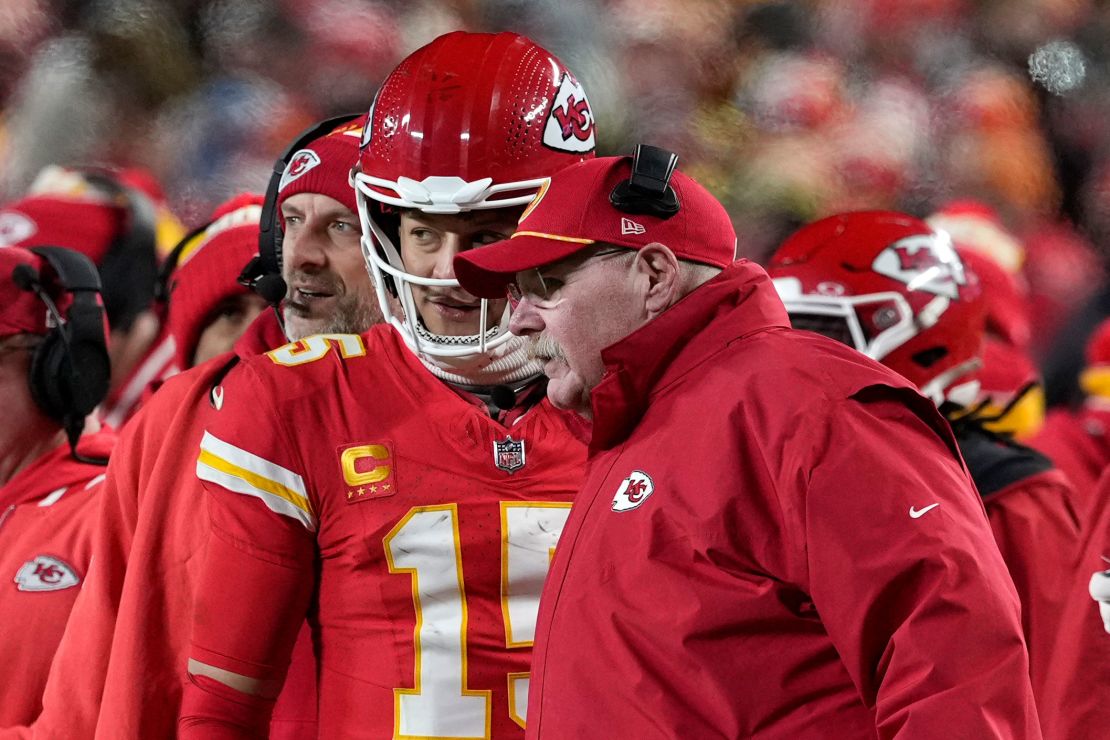 Mahomes talks on the sidelines with head coach Andy Reid during the AFC divisional game against the Houston Texans.