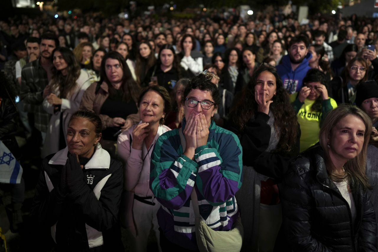 People react to news of the released hostages, as they gather in Tel Aviv, Israel on Sunday.