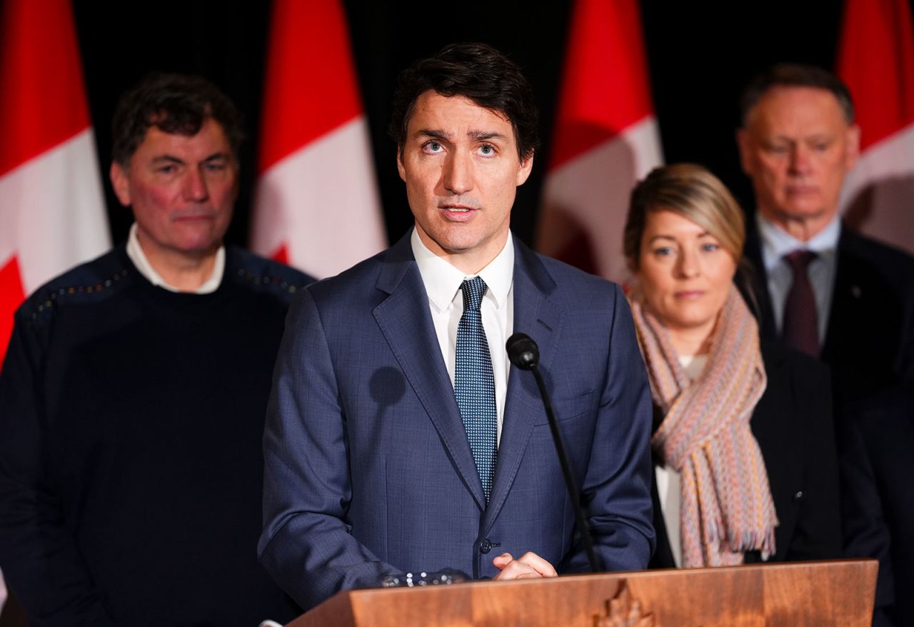 Canadian Prime Minister Justin Trudeau is joined by Minister of Finance Dominic LeBlanc, back left to right, Minister of Foreign Affairs Melanie Joly, Minister of Public Safety David McGuinty, as he holds a press conference on January 21.