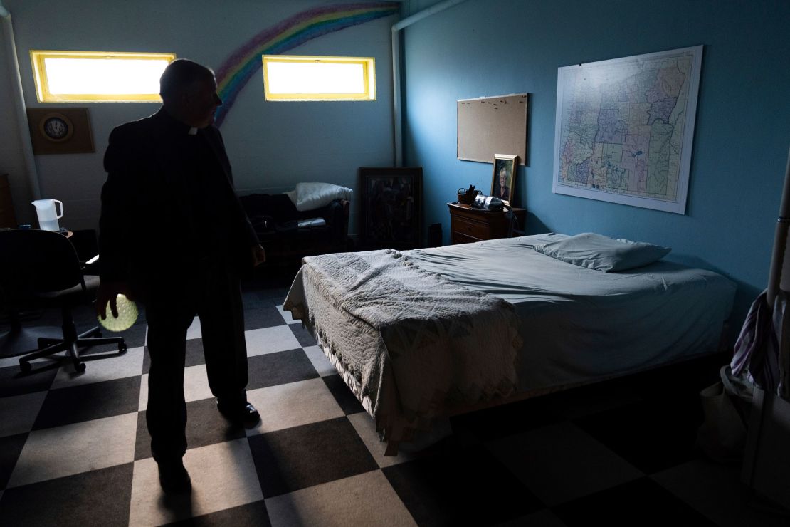 Knutson looks at a map of Oregon hanging above a bed at Augustana Lutheran Church.