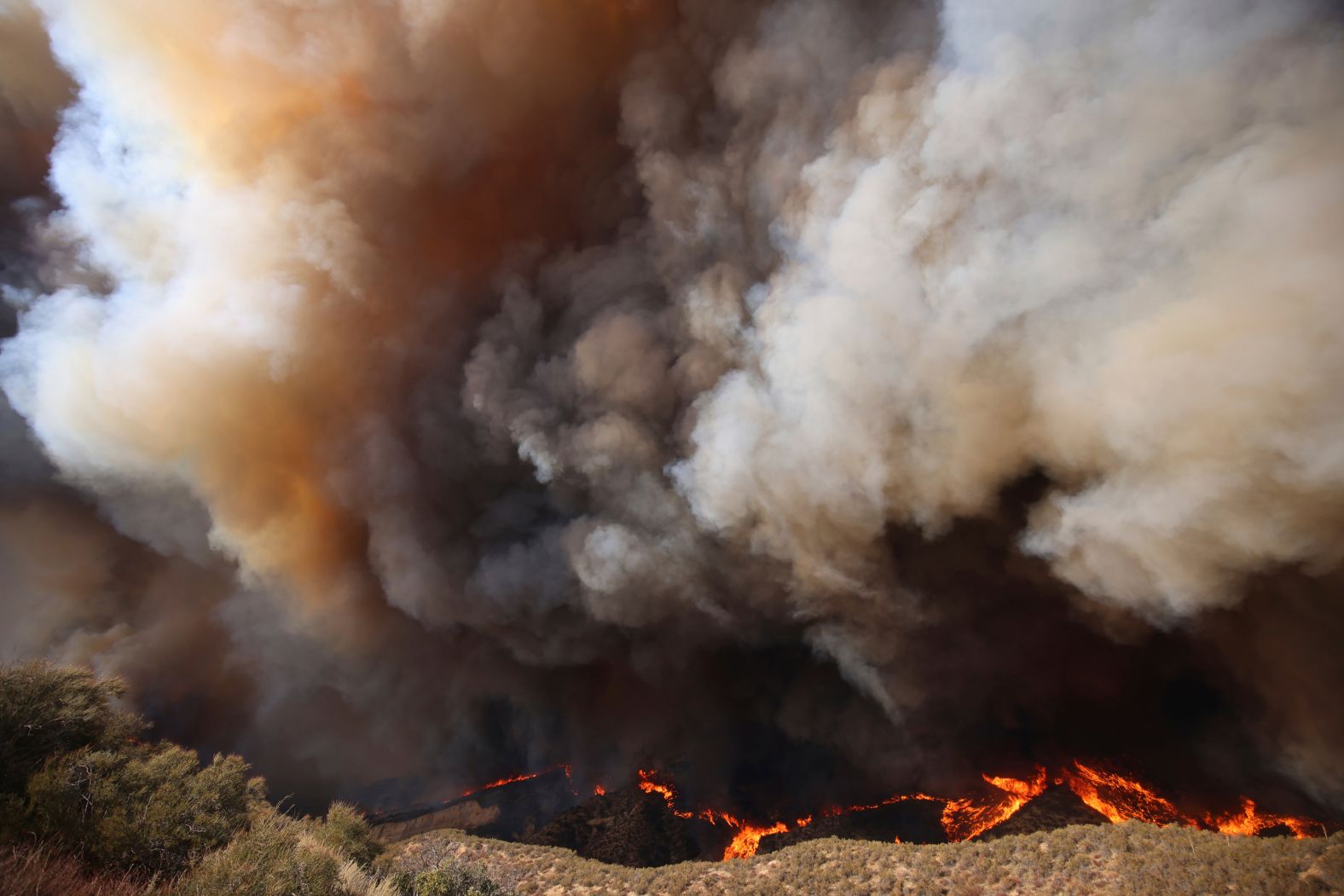 Plumes of smoke rise from the Hughes Fire.