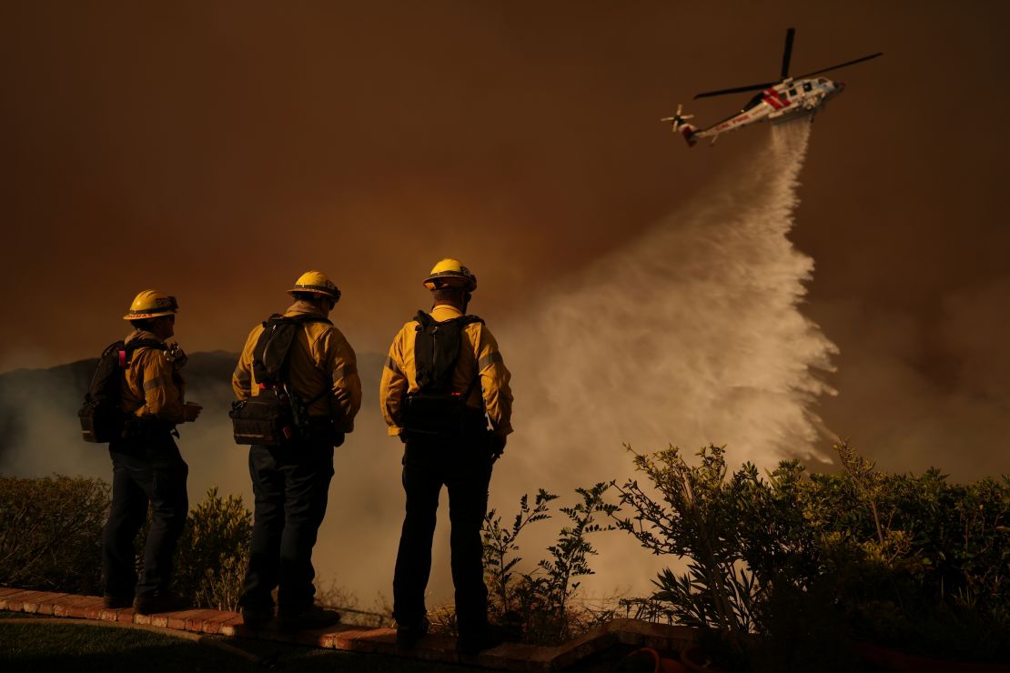 Water is dropped by a helicopter on the Palisades Fire in Mandeville Canyon, in Los Angeles, on January 11.