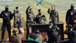 Israeli female soldier hostages wave at a Palestinian crowd before being handed over to the Red Cross in Gaza City, on Saturday, January 25, 2025.