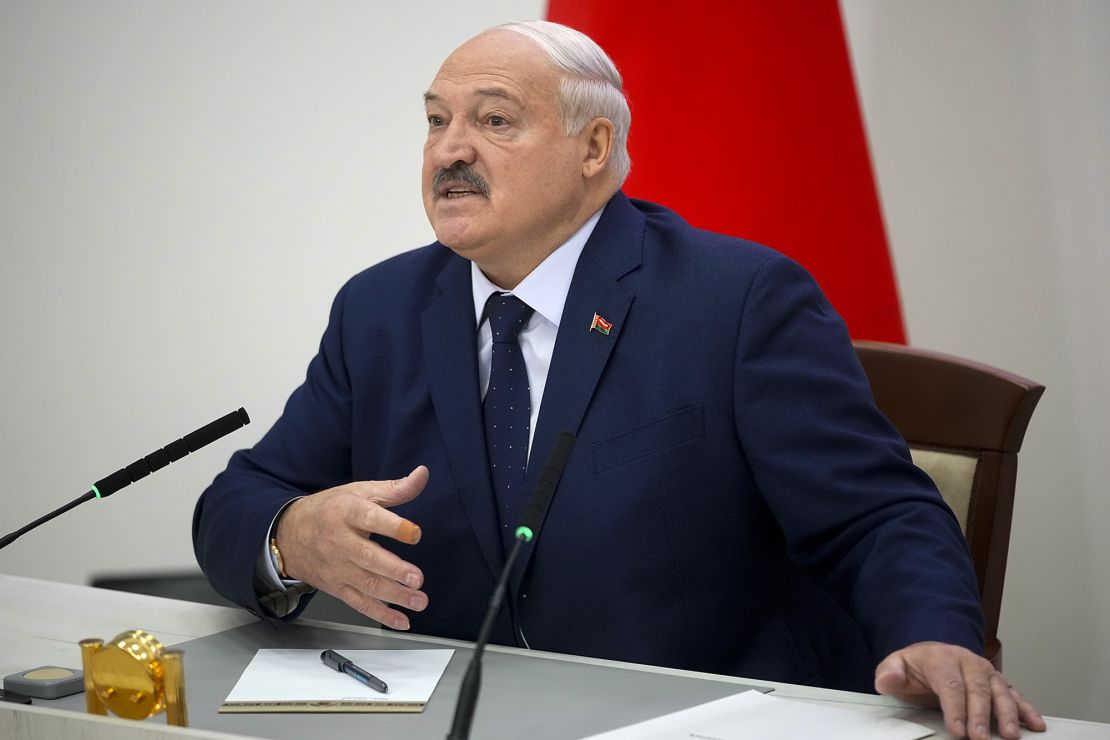 Lukashenko speaks to reporters after casting his ballot on January 26.