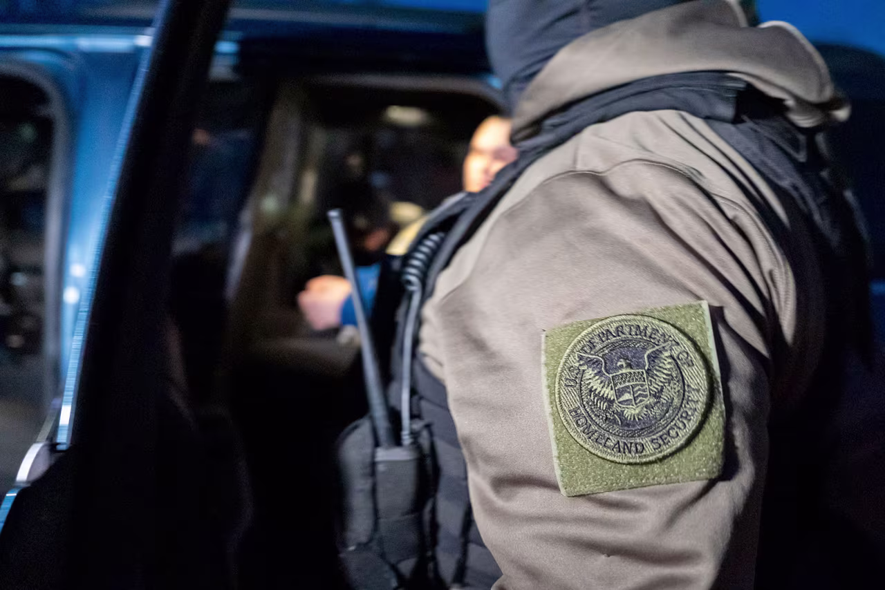 US Immigration and Customs Enforcement officers detain a person, on Monday, in Silver Spring, Maryland.