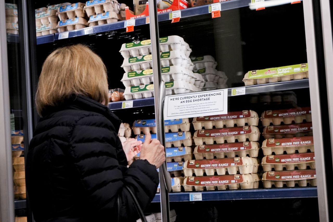 A shopper browses for eggs in front of a sign posted about egg shortages at a PCC Community Markets grocery store in Seattle on January 27.