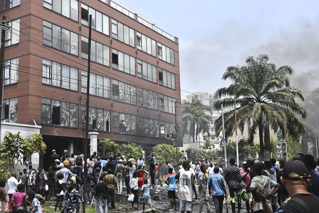 People attack the Rwandan Embassy in Kinshasa on Tuesday.