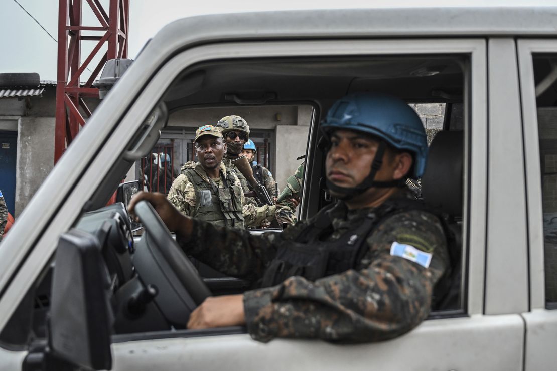 M23 rebels look at a UN peacekeeping vehicle in Goma, on January 29.