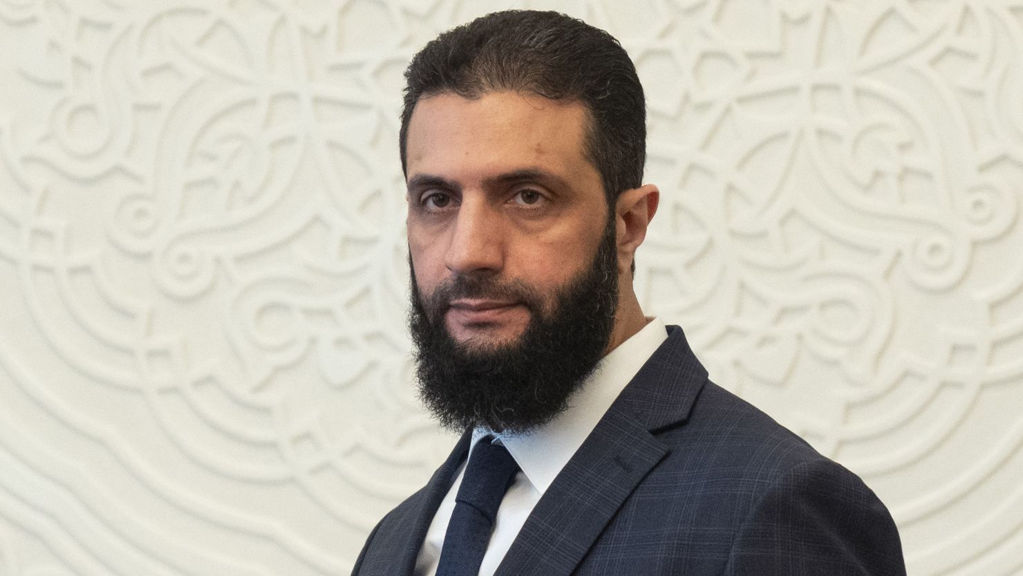 FILE - Syria's de facto leader Ahmad al-Sharaa, formerly known as Abu Mohammed al-Golani, walks in the presidential palace ahead of his meeting with Walid Ellafi, Libyan minister of state for communication and political affairs, in Damascus, Dec. 28, 2024. (AP Photo/Mosa'ab Elshamy, File)