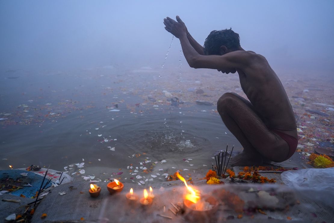 A Hindu devotee performs rituals after taking a holy dip on Thursday, January 30.