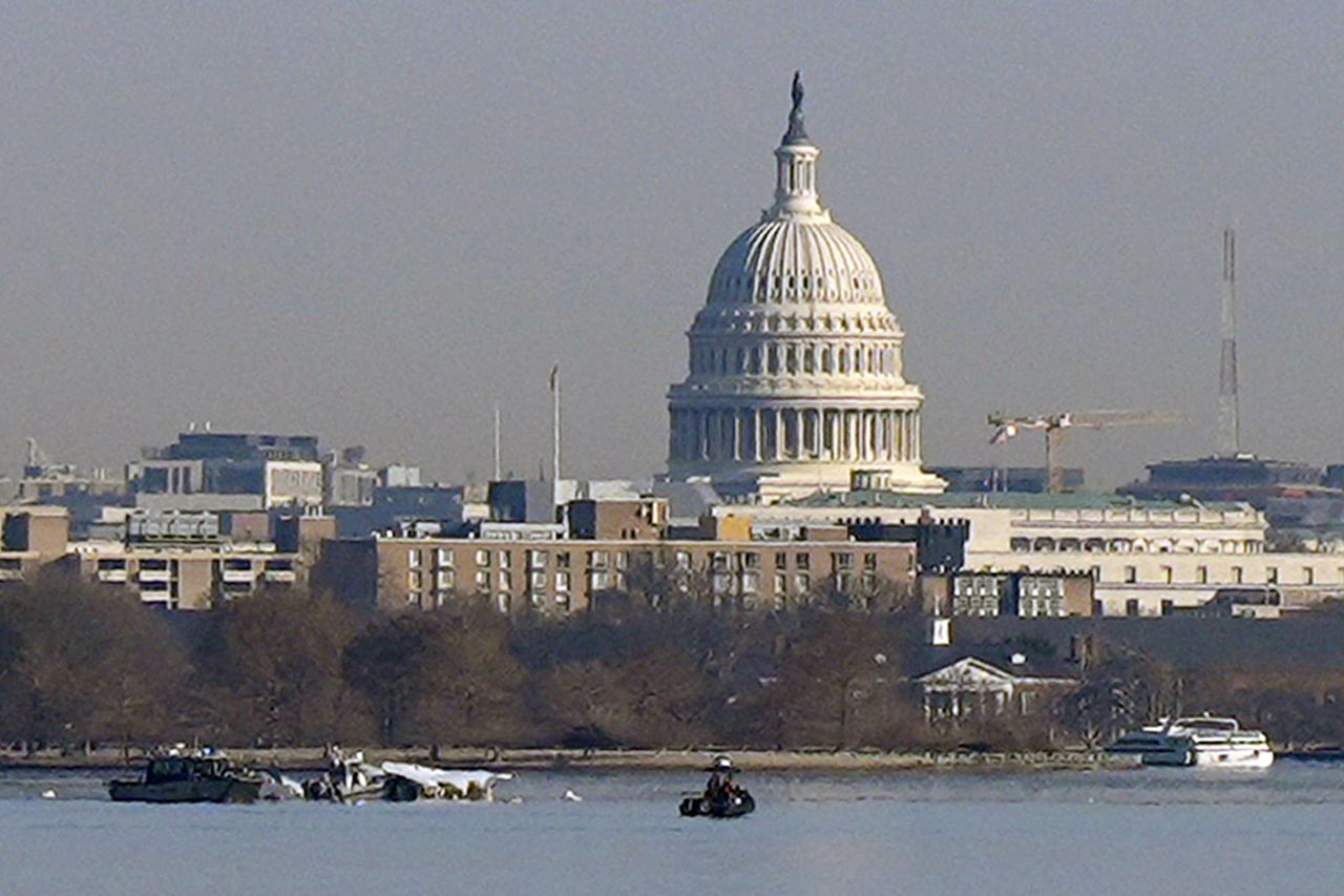 Search efforts are seen around the wreckage site in the Potomac River, early Thursday.