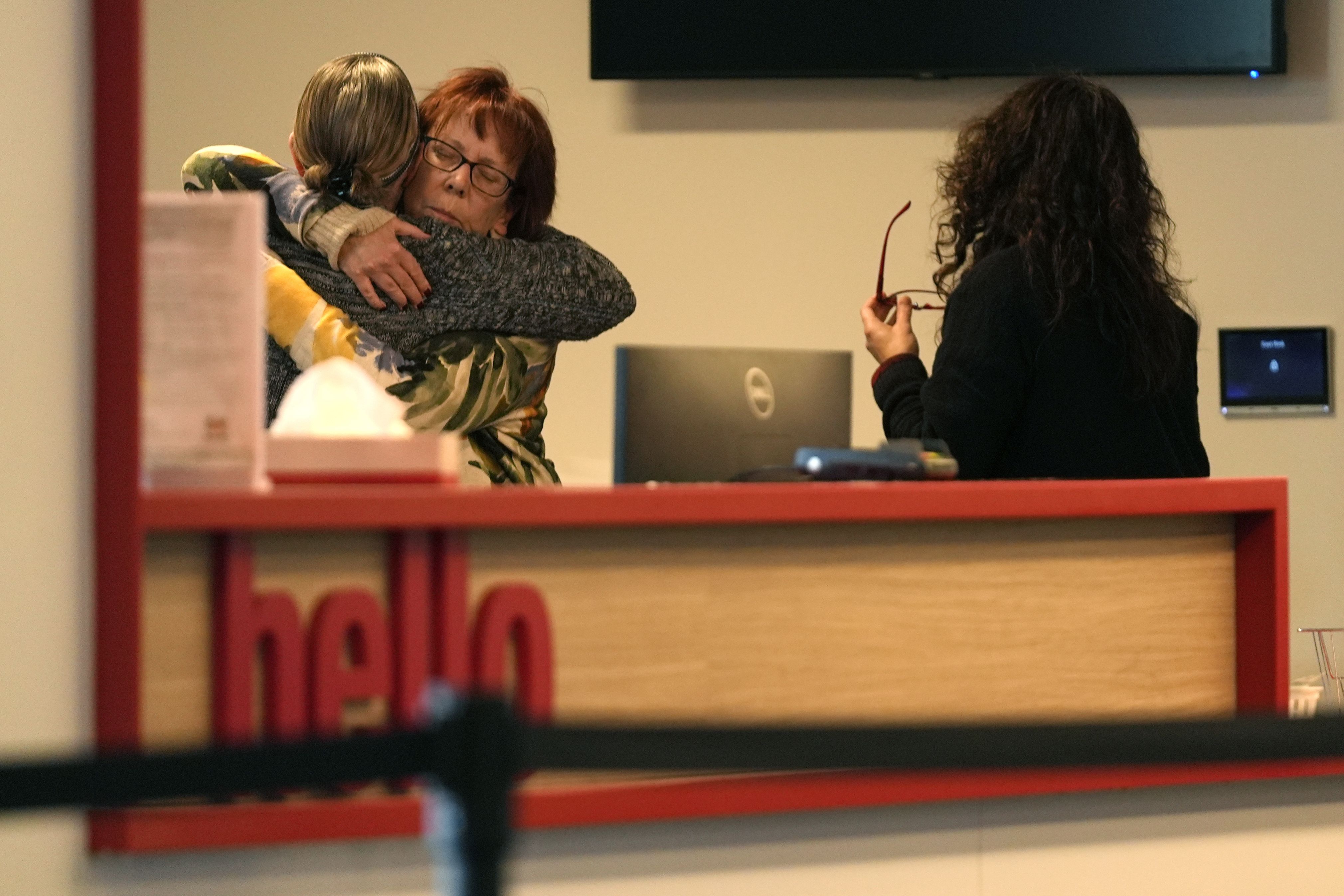 Women embrace in the reception area at The Skating Club of Boston on Thursday. Several members of the figure skating community were aboard the jet, returning from a <a href='https://www.cnn.com/us/live-news/plane-crash-dca-potomac-washington-dc-01-29-25#cm6jafz8o00003b6n4hxr06jf'>developmental camp</a> in Wichita, US Figure Skating said. The Skating Club of Boston <a href='https://www.cnn.com/us/live-news/plane-crash-dca-potomac-washington-dc-01-29-25#cm6jgs31h0000356muf7ke5dv'>named six victims</a>, including <a href='https://x.com/rockerskating/status/1633299737997725697' target='_blank'>Evgenia Shishkova and Vadim Naumov</a>, the 1994 world champions in pairs.