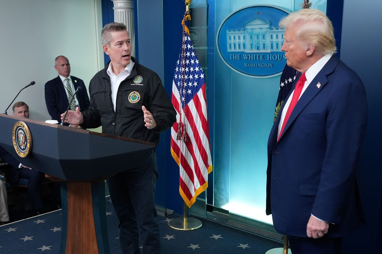 President Donald Trump stands beside Transportation Secretary Sean Duffy during a briefing at the White House in Washington, DC on Thursday.