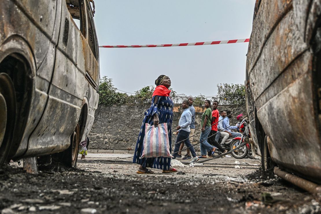 Residents will walk by a burnt vehicle in Sesame, the Democratic Republic of the Congo on Friday, January 31st.