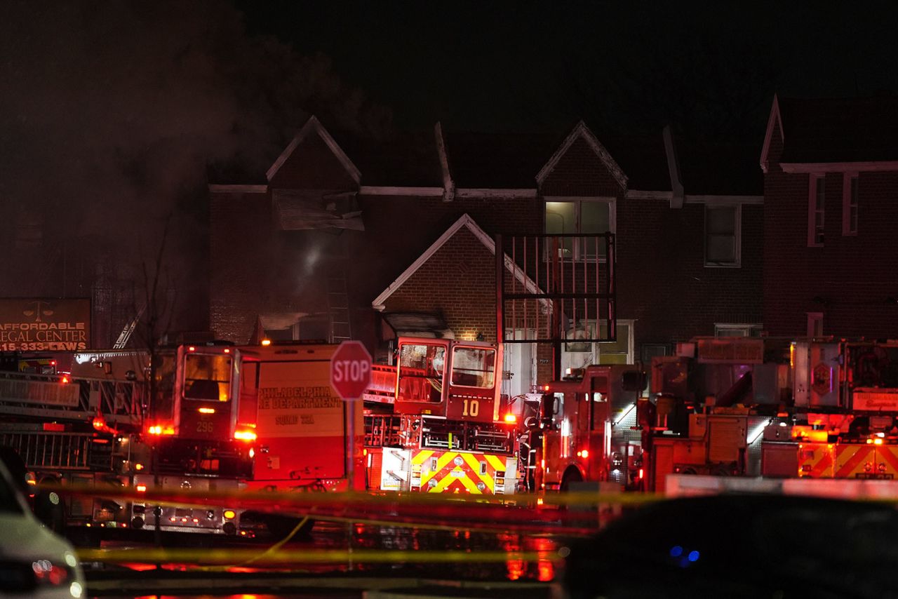 First responders work the scene after a plane crash in Philadelphia, on Friday.