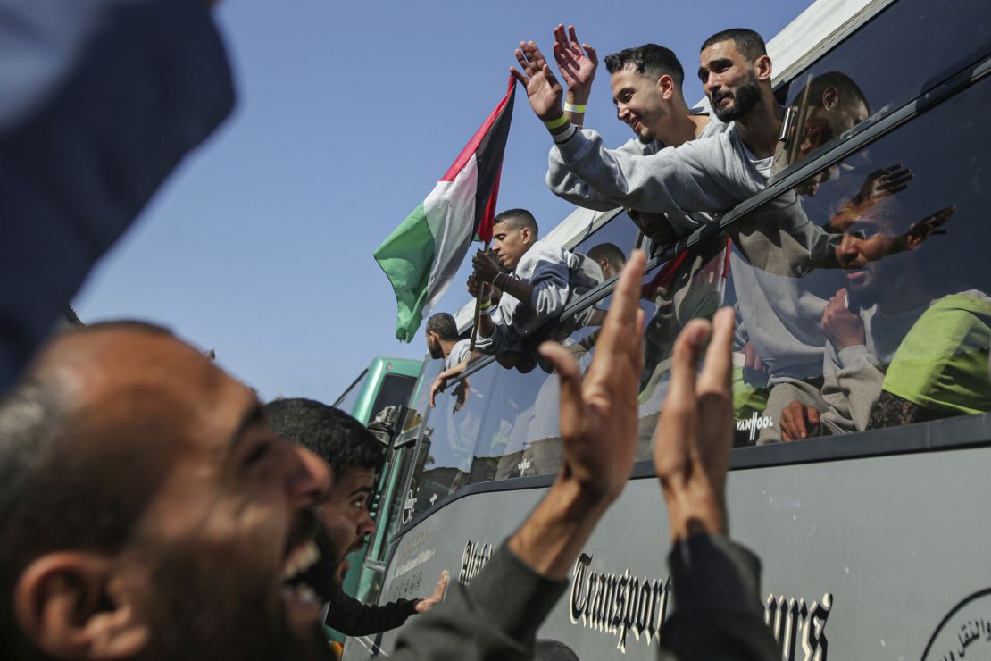 Freed Palestinian prisoners are greeted by a crowd as they arrive in the Gaza following their release on February 1.