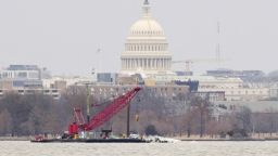 Con el Capitolio de EE.UU. de fondo, una grúa se encuentra en el río Potomac el domingo. Los equipos de salvamento la utilizarán esta semana para retirar grandes piezas de los restos del vuelo 5342 de American Airlines.