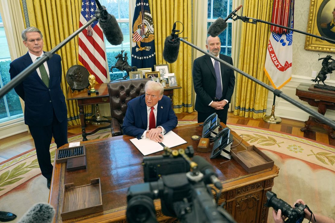 President Donald Trump speaks as Treasury Secretary Scott Bessent, left, and Commerce Secretary nominee Howard Lutnick listen as Trump prepares to sign an executive order in the Oval Office of the White House, Monday, Feb. 3, 2025, in Washington.