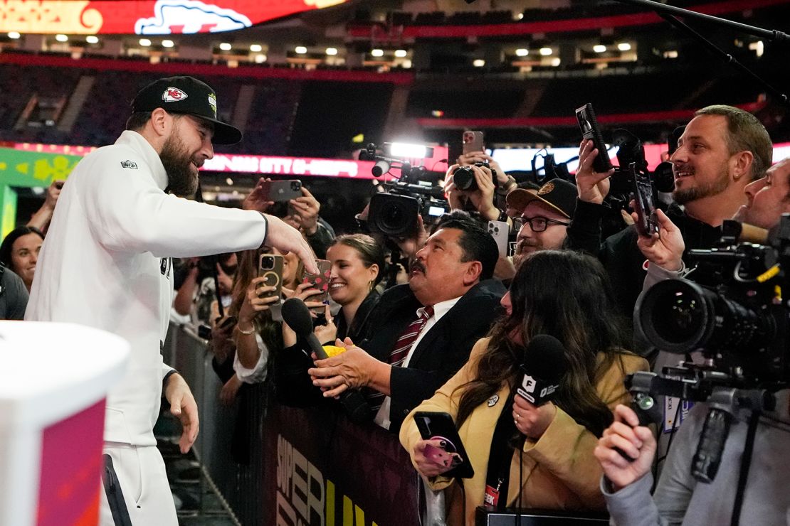 Kansas City Chiefs tight end Travis Kelce (87) greets Guillermo Rodriguez of ABC's "Jimmy Kimmel Live!" during Super Bowl 59 Opening Night.