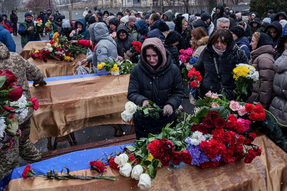 Mourners come to say goodbye to people who were killed by a Russian strike on a residential building in Poltava, Ukraine, in February.