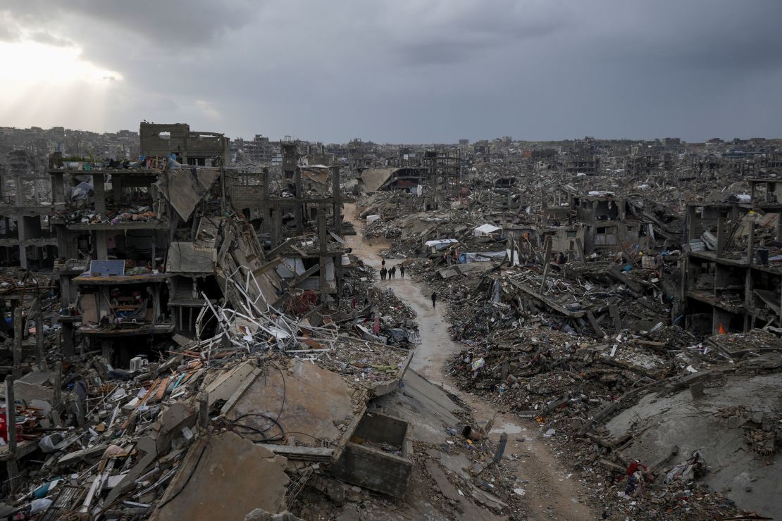 Palestinians walk through destruction caused by the Israeli air and ground offensive in Jabalya, Gaza, on February 6.