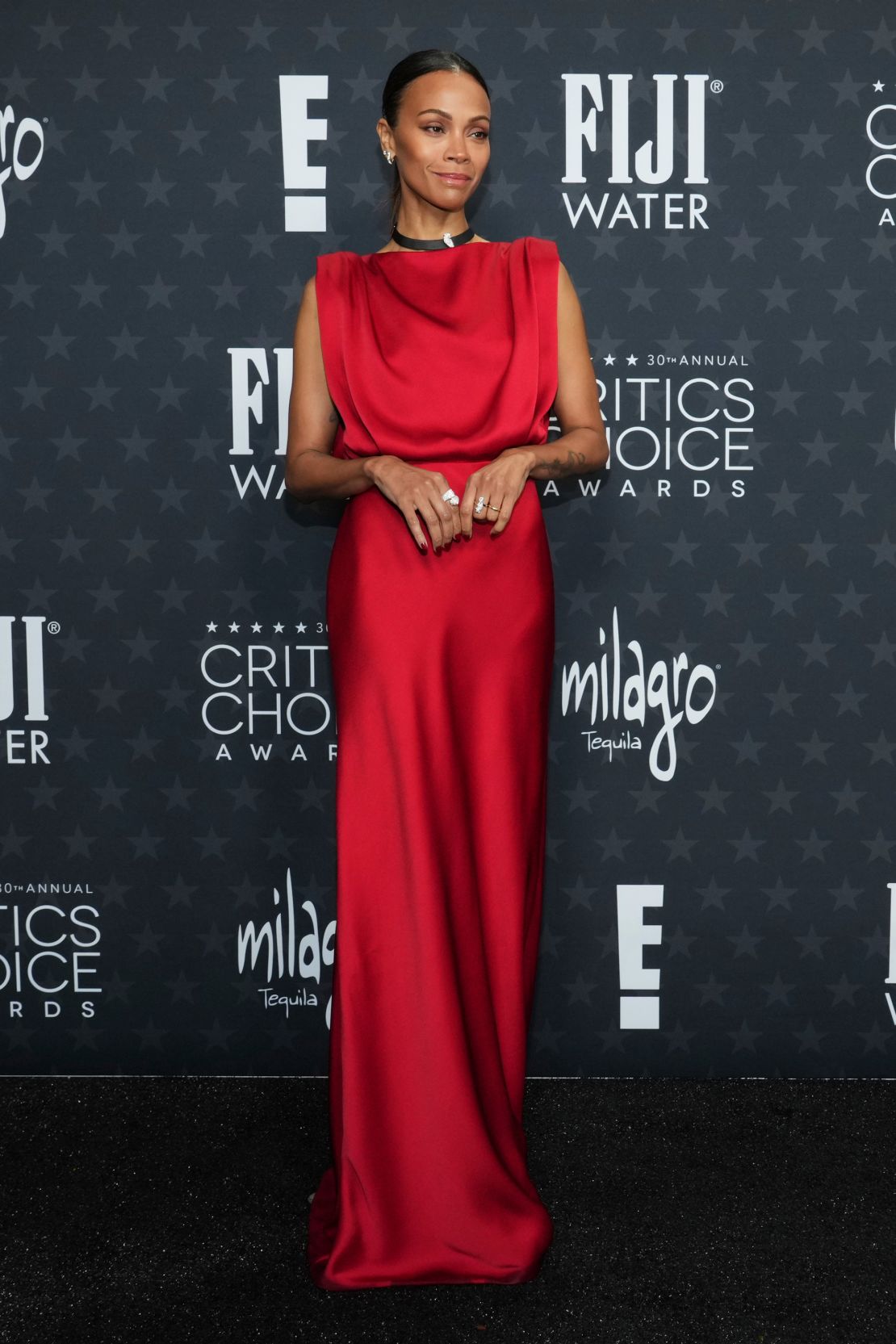 Zoe Saldaña arrived in an elegant floor-length silk Saint Laurent dress and jewelry Cartier Choker.