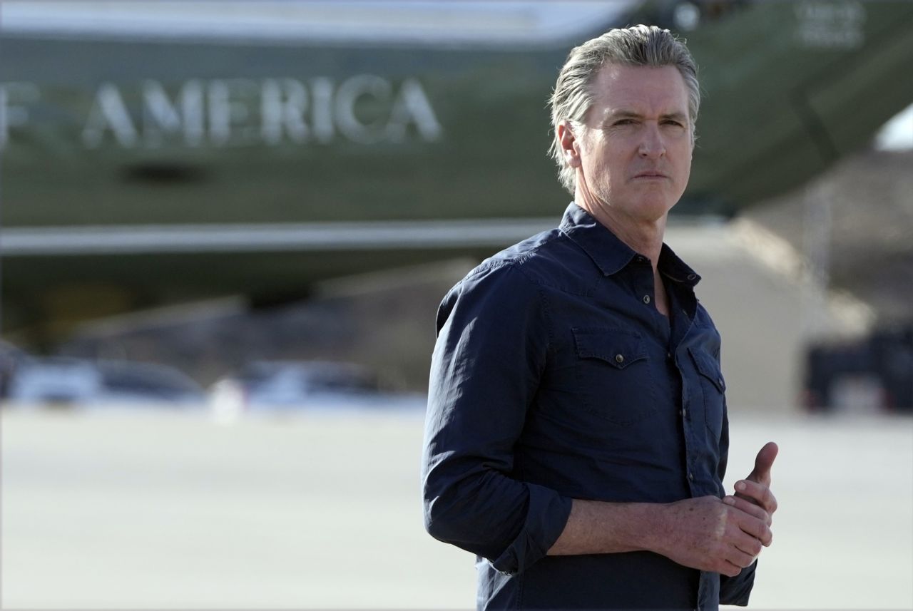 California Gov. Gavin Newsom waits for President Donald Trump and first lady Melania Trump to step off Air Force One upon their arrival to Los Angeles on January 24.