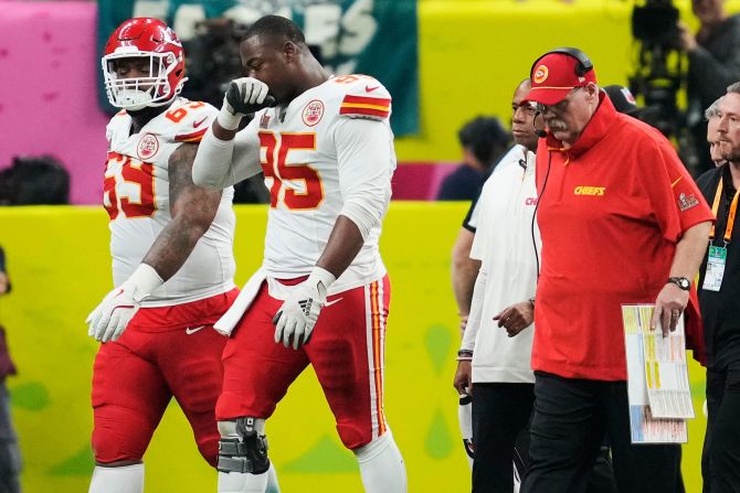 Chiefs defensive tackle Chris Jones, second from left, walks off the field after an injury. Head coach Andy Reid is on the right.