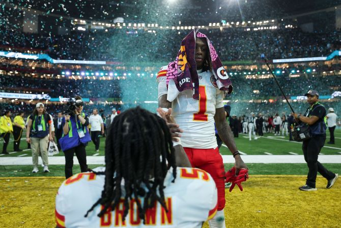 Chiefs wide receiver Xavier Worthy shakes hands with teammate Marquise Brown after the game.