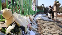 People mourn the death of a pupil stabbed to death allegedly by a teacher, outside of an elementary school in Daejeon, South Korea, on Tuesday, February 11, 2025.