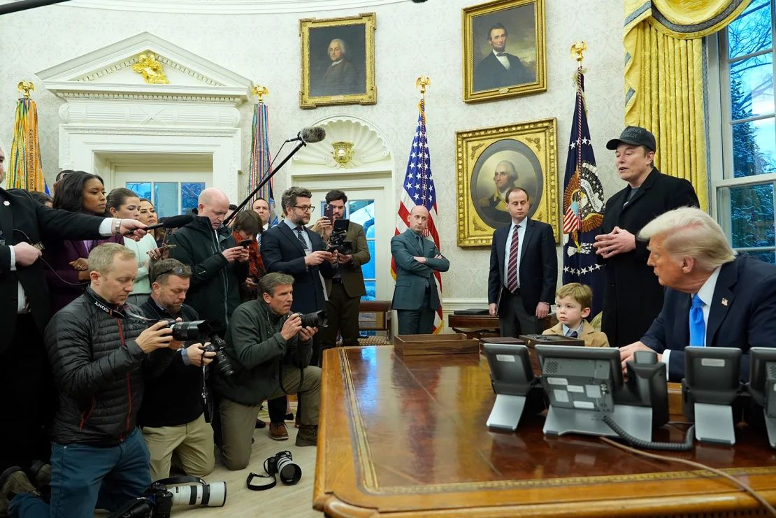 Elon Musk speaks during an event at the Oval office while President Donald Trump and the son of Musk, X Æ A-XII, listen to at the White House, on Tuesday, February 11, 2025, in Washington.