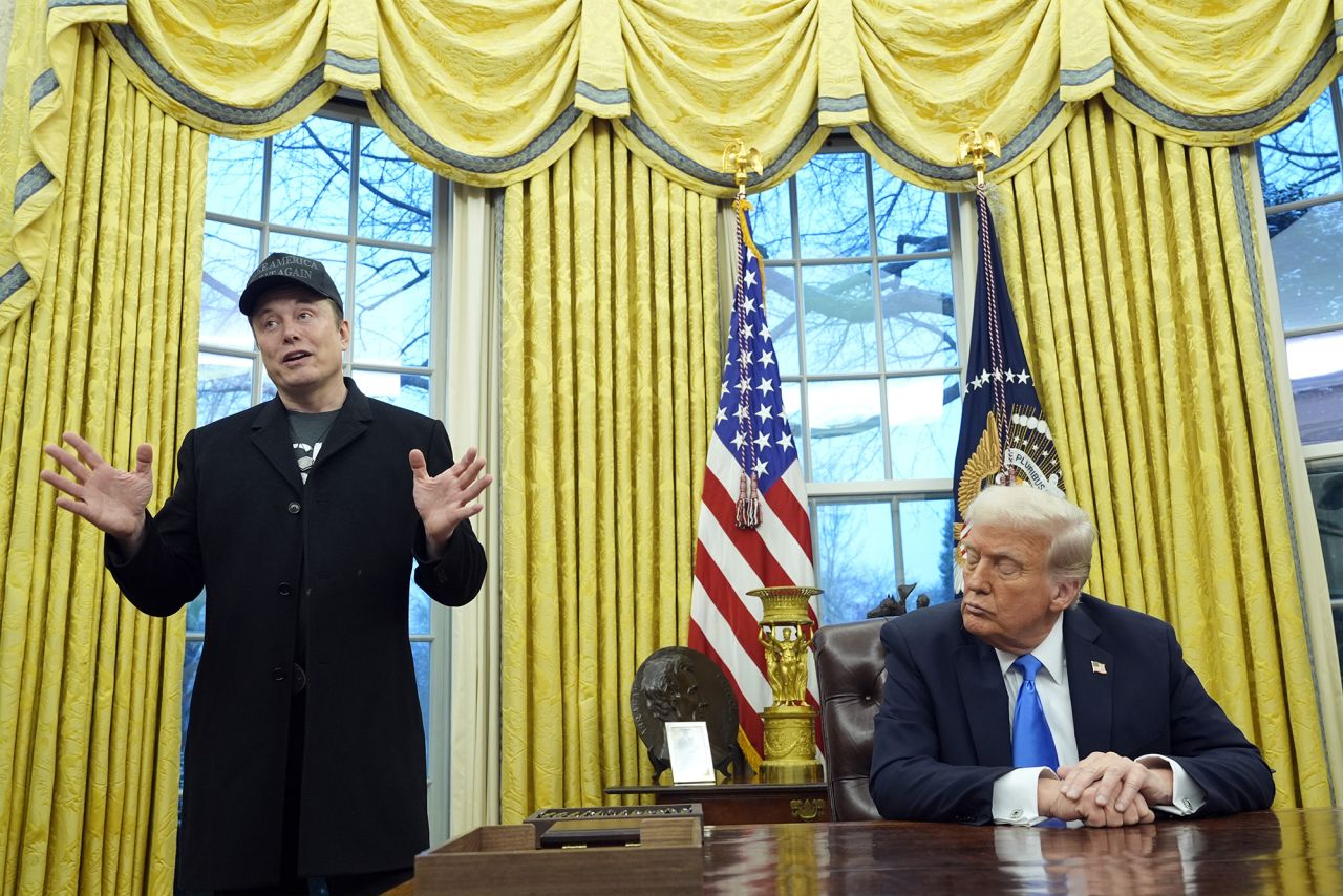 President Donald Trump listens as Elon Musk speaks in the Oval Office of the White House, on Tuesday.
