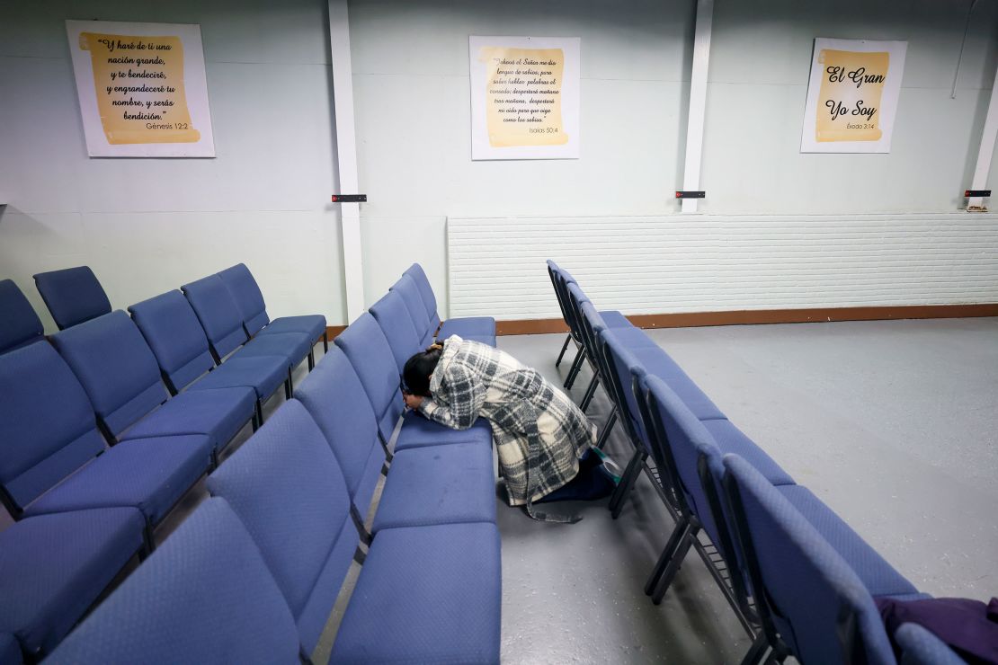 Kenia Colindres falls to her knees and prays at Fuente de Vida church in Tucker, Georgia, after learning her husband will be transferred to Stewart Detention Center.