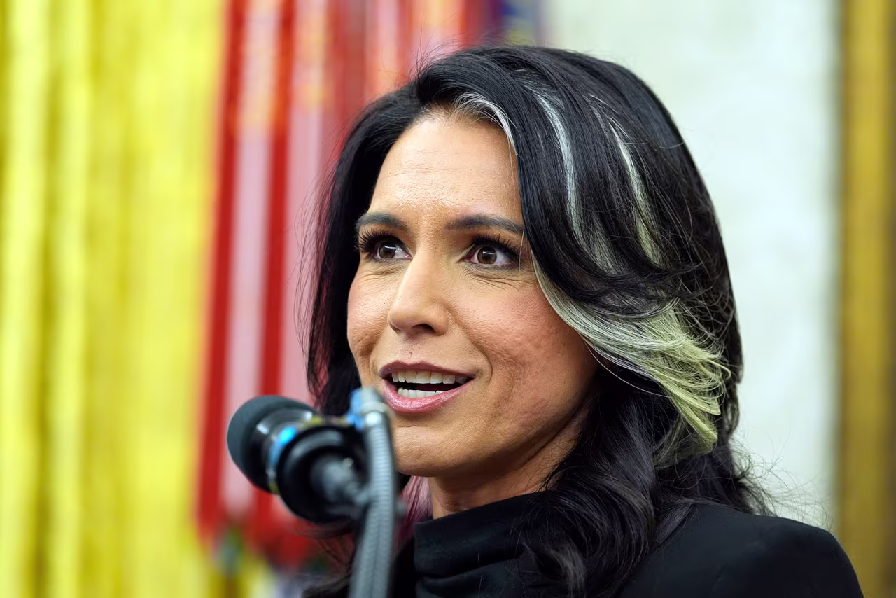 Tulsi Gabbard listens to President Donald Trump at the Oval Office of the White House, in Washington on February 12.