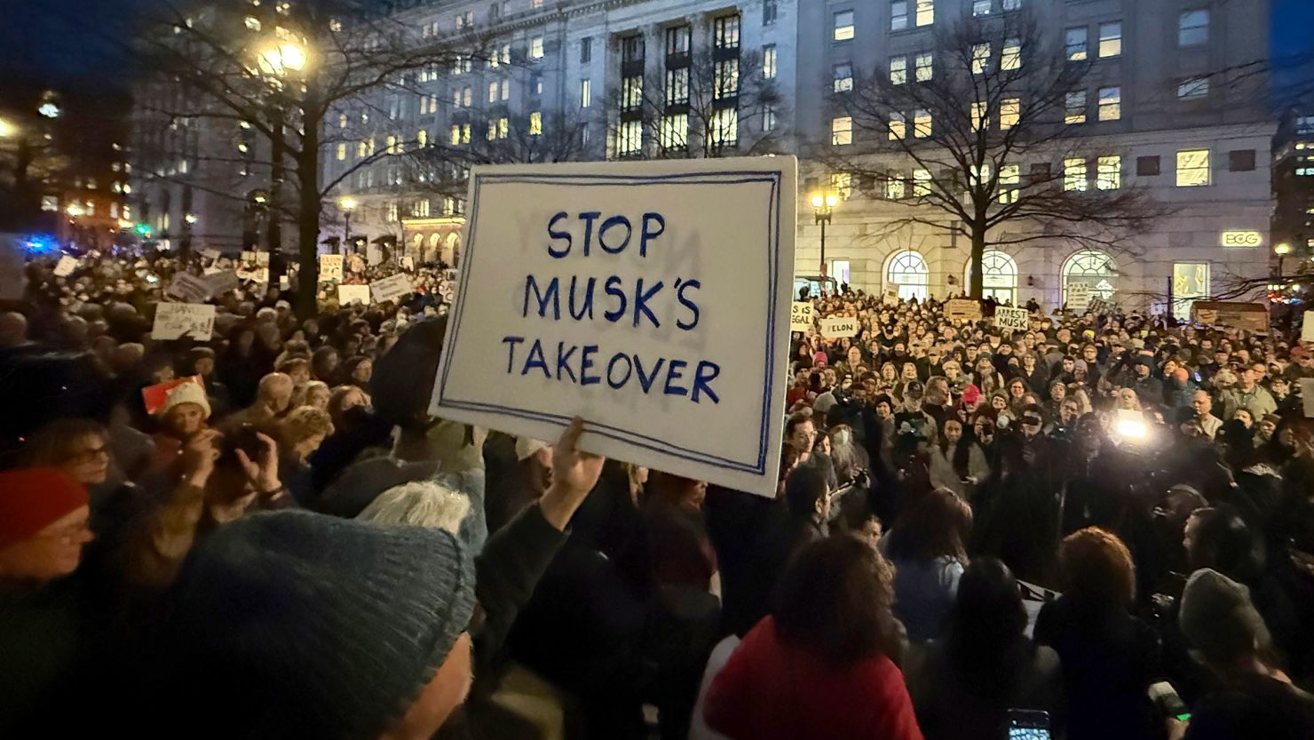 People protest Elon Musk outside the Treasury Department in Washington, DC, on February 4, 2025.