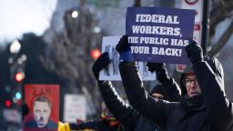Demonstrators rally in support of federal workers outside of the Department of Health and Human Services, Friday, Feb. 14, 2025, in Washington. (AP Photo/Mark Schiefelbein)