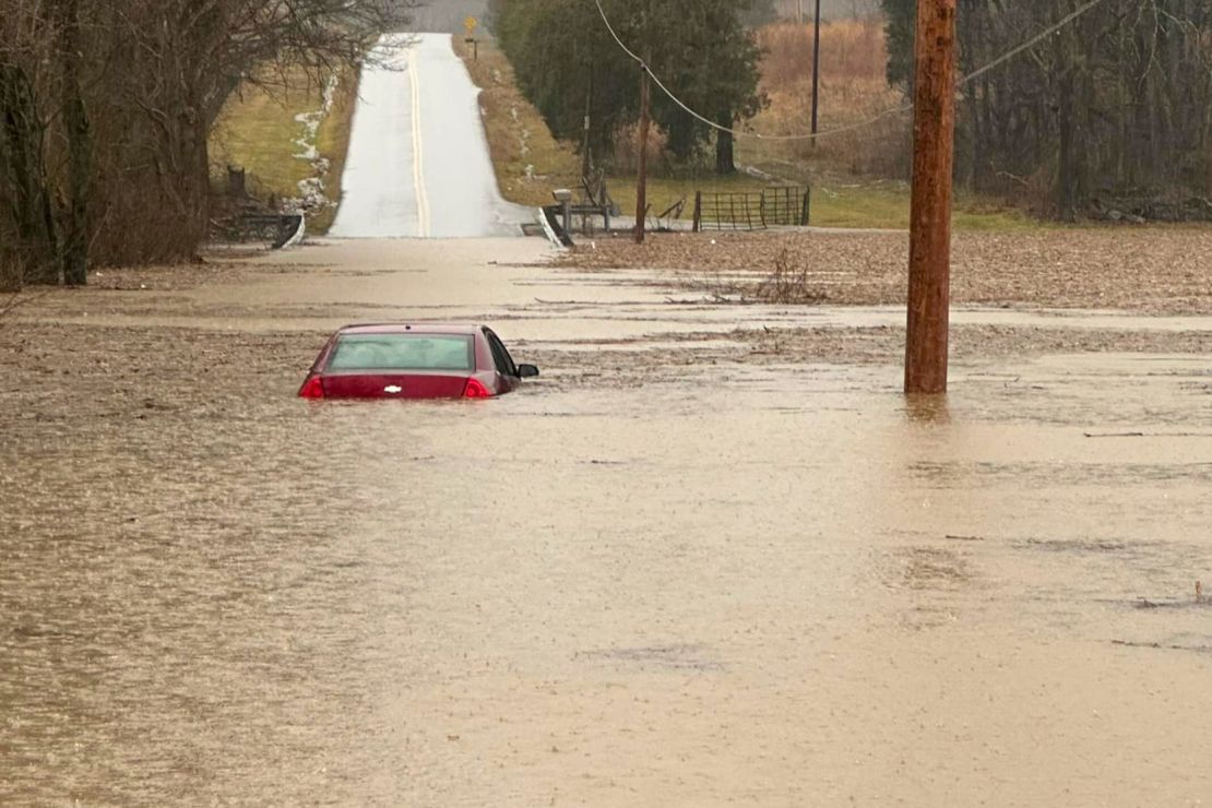 A car is partially submerged by floodwaters near Bowling Green, Kentucky, on Saturday, Feb. 15, 2025.