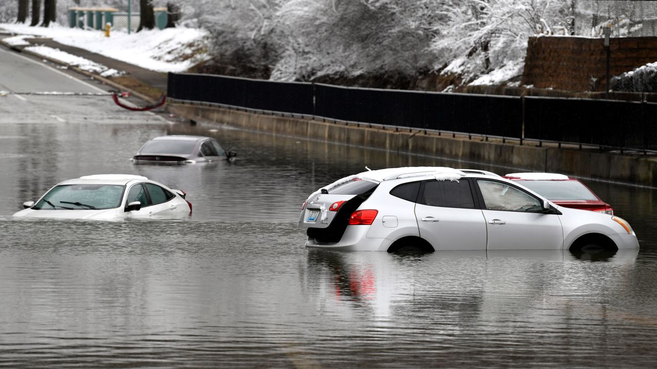 Cars sit in floodwaters at a railroad underpass in Louisville, Ky., Sunday, Feb. 16, 2025. (AP Photo/Timothy D. Easley)