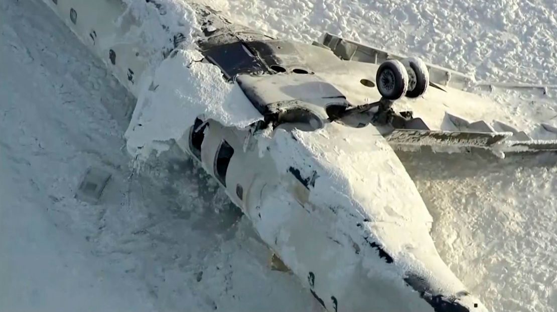 The wreckage of the overturned plane remained on the runway Tuesday at Toronto Pearson International Airport.