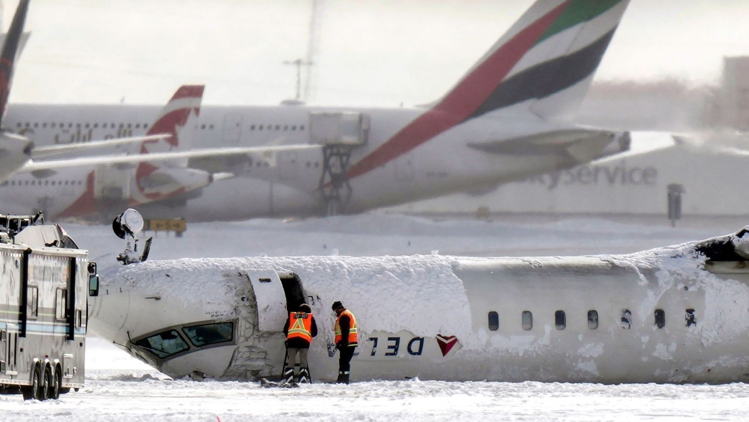 Delta Air Lines Flight 4819 lies upside down at Toronto Pearson Airport on Tuesday, a day after its crash landing. Everyone on board survived.